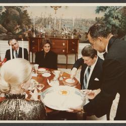 John H. Johnson serves cake to President Ronald Reagan at his 72nd birthday on February 6, 1983.