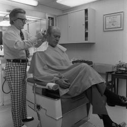 President Gerald Ford receives a haircut from Milton Pitts in 1974