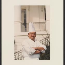 This is a portrait photograph of White House Executive Pastry Chef Roland Mesnier in front of the South Portico of the White House.

This photograph is part of a personal collection belonging to former White House Executive Pastry Chef Roland Mesnier. Chef Mesnier created elaborate desserts for White House events from 1980 to 2004.